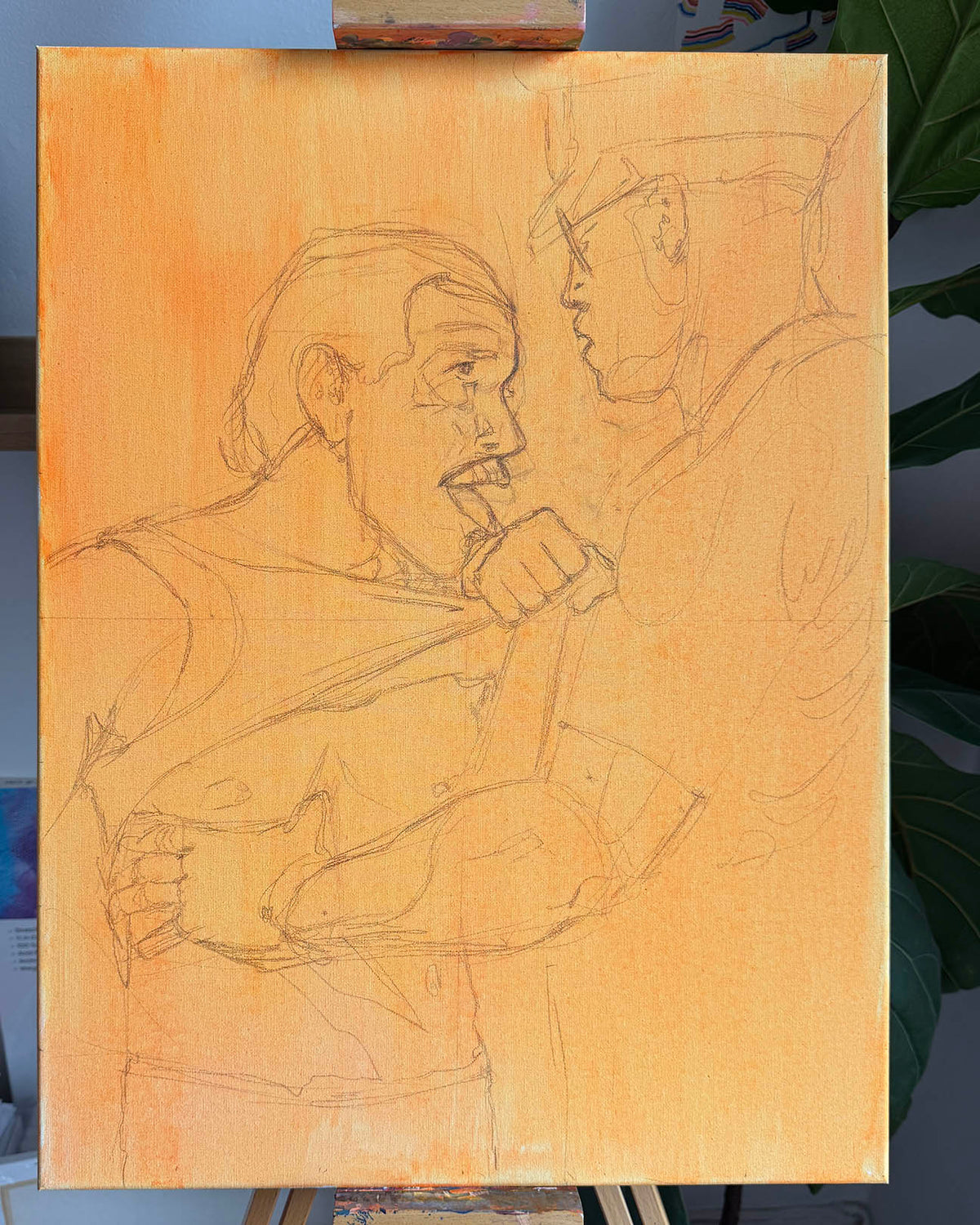 A large square canvas painting on an easel, featuring a pencil sketch of two men in a close, expressive pose. The canvas has a warm orange-yellow painted background with fine gray sketch lines.
